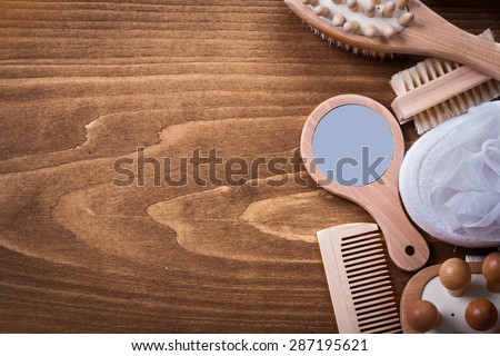 Wooden hairbrush hand glass massagers bath sponge scrubbing brush on pine vintage board healthcare concept