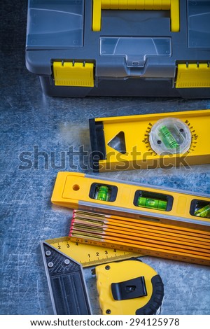 Toolbox construction levels and instruments of measurement on scratched metallic surface maintenance concept.