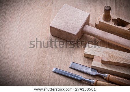 Lump hammer shaving plane metal flat chisels and wooden stud on brown board construction concept.