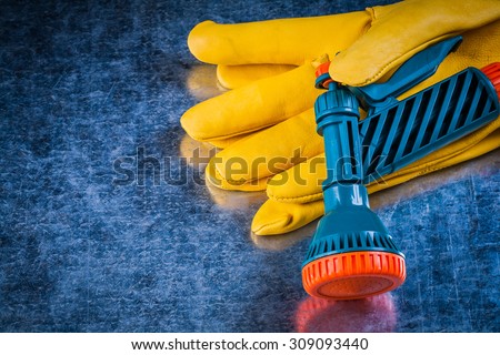 Top view of leather gardening gloves spray nozzle agriculture concept.