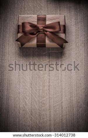 Wrapped vintage giftbox with brown ribbon celebration concept.