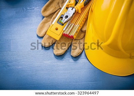 Collection of pliers hard hat wooden meter protective gloves.
