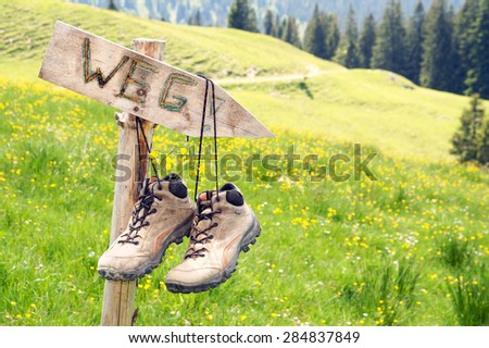 Mountain boots hanging on a signpost