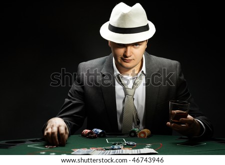 man wearing hat is playing poker in casino
