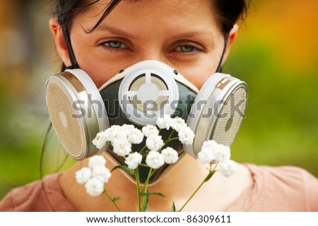 caucasian woman is wearing a gas mask