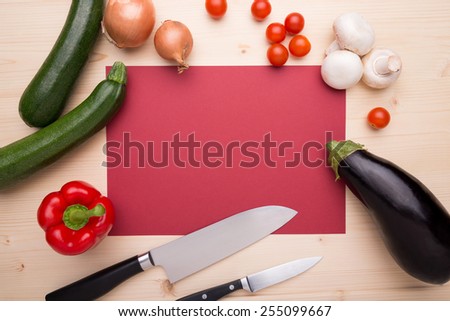 Cooking items arranged around a red piece of paper