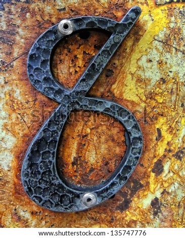 number eight in iron on painted wood, vintage rustic grunge look