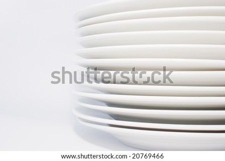 stack of white dinner plates on white background,side-view