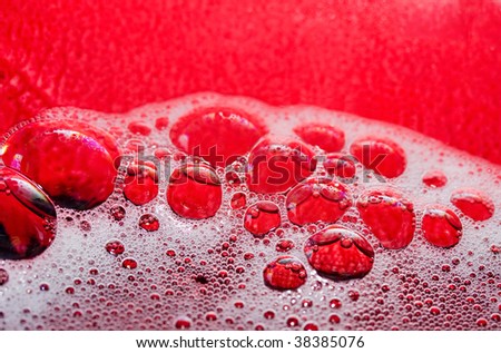 closeup of soap bubbles, white lather, red background