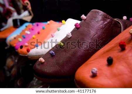 row of traditional moroccan shoes, handmade babouches, in multicolored leather
