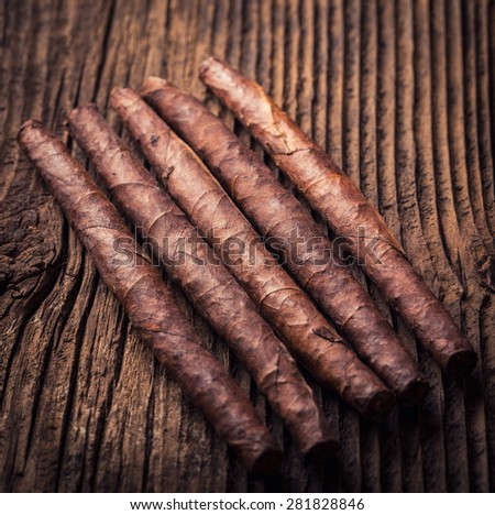quality cigars for relaxing on an old wooden table