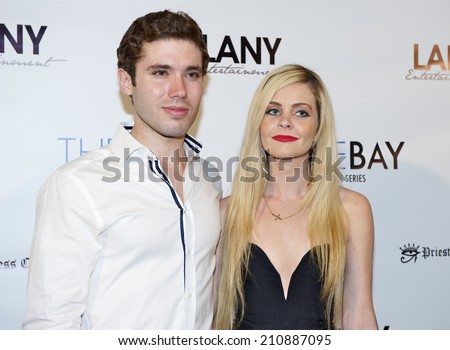 LOS ANGELES/CALIFORNIA - AUGUST 4, 2014: Producer Kristos Andrews & guest walk the red carpet at \