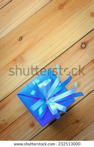 Blue gift box for new year on wooden background