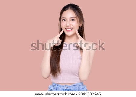 Similar – Image, Stock Photo A pretty girl in a hat is sitting on the sofa near a Christmas tree, dressed up for the holiday, the child is smiling and rejoicing at the gift