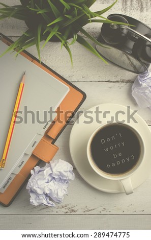 Don\'t worry Be happy - Text on top view of coffee on office table with vintage effect