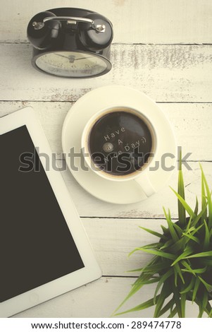 Have a nice day - Text on top view of coffee on office table with vintage effect