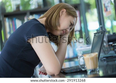 Stressed working Asian woman have a coffee at cafe