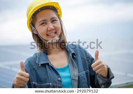 Portrait Asian engineer woman front of  solar panel