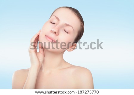 Beautiful spa woman touching her face. Youth and skin care concept. Perfect skin