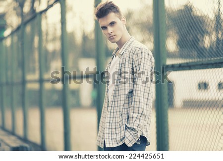 Outdoor portrait handsome man model with deep look in urban style, street fashion, vintage photo