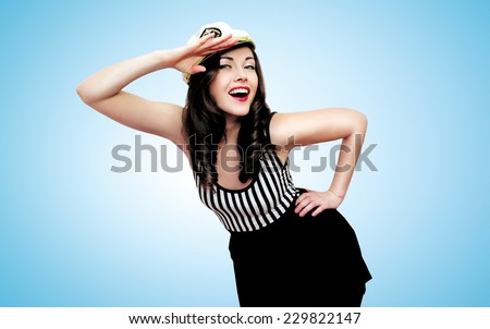 Travel, cruise, sea and people concept - pretty smiling woman brunette of a sailor saluted in pin-up style