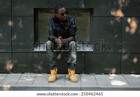 Street fashion concept - stylish young african man in the city