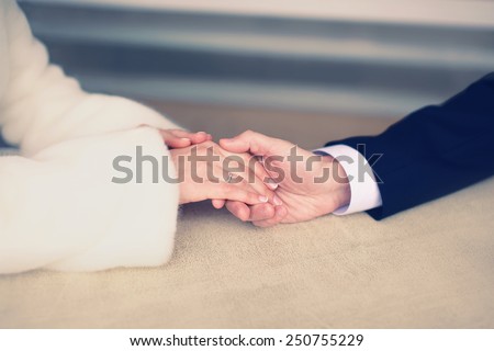 Wedding, engagement and date concept - couple in love, man gently holds the hand of a woman, soft pastel vintage colors
