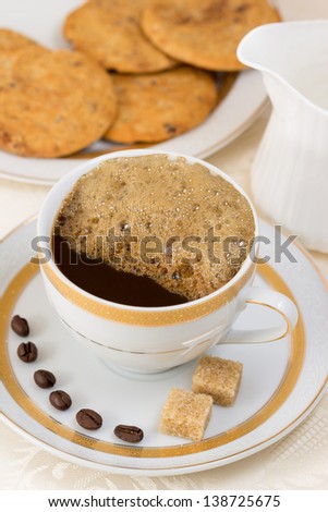 Coffee, more cream, biscuits, brown sugar cubes and coffee beans