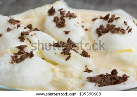 Floating egg white foam on milk flavored with vanilla and lemon zest