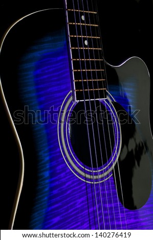 acoustic guitar.blue color.black background