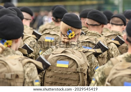 Woman soldier. Woman in army. Ukrainian flag on military uniform. Ukraine troops. Stockfoto © 