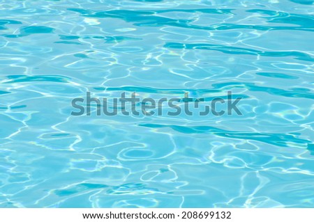 Shiny blue pool surface on a sunny summer day
