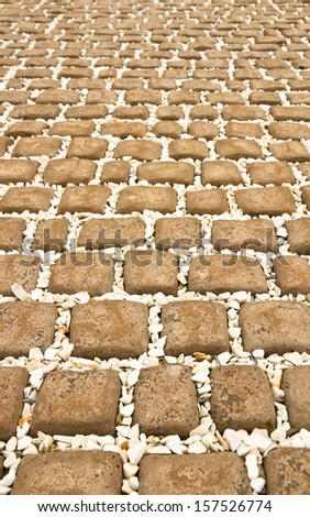 Square bricks and white stone floor