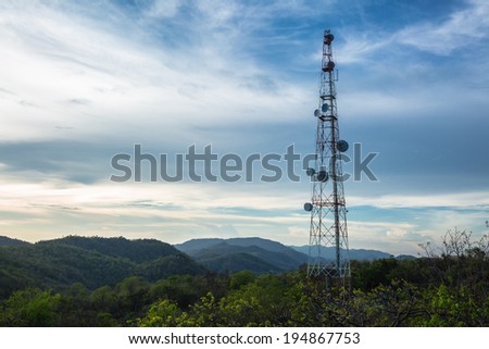 A radio communications tower at top of green mountain