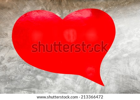 Big red heart on bare cement wall background
