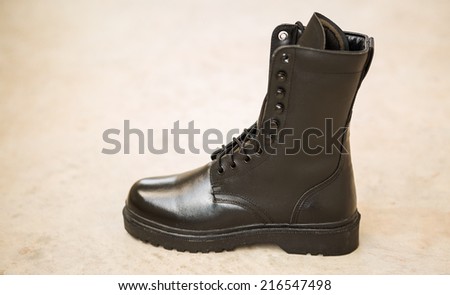Black Leather Army Boots on blare cement floor