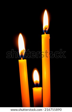 Candles and light in dark black