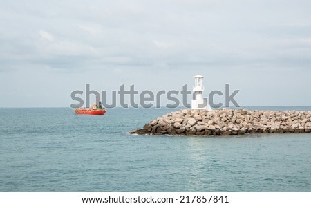 White lighthouse on stone water break