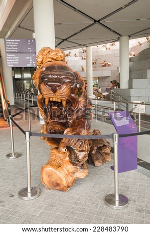 SINGAPORE-NOVEMBER 02:Carved lion wood is near escalator at the Flower Dome within the Gardens by the Bay in Singapore in November 02,2014