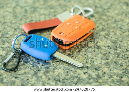 Car key in colorful silicone on polished stone