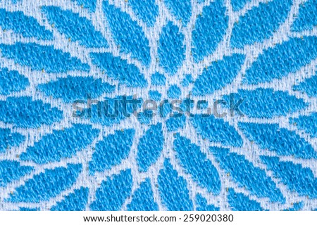 Stitch blue flower design on fabric