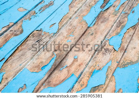 Cracked surface on old wooden blue desk
