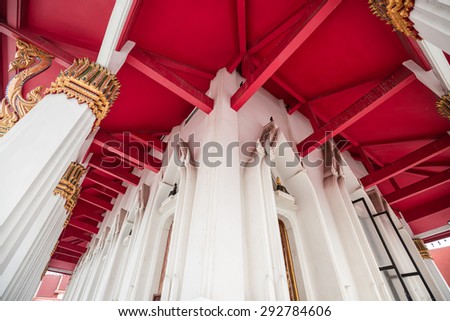 BANGKOK,THAILAND - JULY1,2015 : White poles and red wooden ceiling of big hall in  thai buddhist temple in Bangkok,Thailand