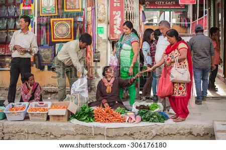 LEH LADAKH , INDIA - AUGUST 11 : The local women are selling fruits and vegetables on the street market in Leh Ladakh,India on August 11, 2015.