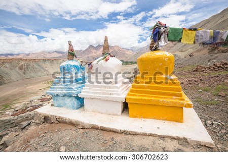 LEH LADAKH , INDIA - AUGUST 11 : The three small pagodas with praying flags are located on the top of mountain in Leh Ladakh,India on August 11, 2015.