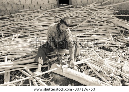 LAMAYURU, INDIA - AUGUST 6 : The young unidentified carpenter are working in village at Lamayuru,India on August 6,2015 ; Black and white image
