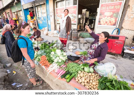 LEH LADAKH , INDIA - AUGUST 11 : The local women are selling fruits and vegetables on the street market in Leh Ladakh,India on August 11, 2015.
