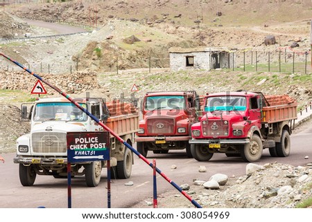 LEH LADAKH , INDIA - AUGUST 11 : The big colorful trucks are parking at police check point on Indian Himalayas high altitude road in Leh Ladakh,India on August 11, 2015.