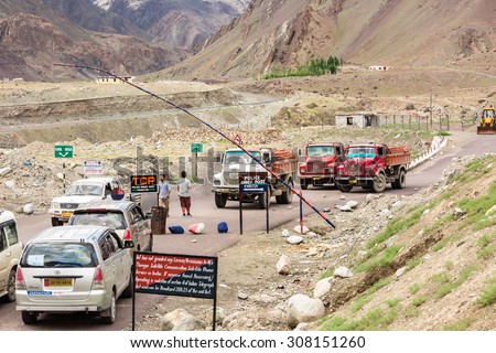 LEH LADAKH , INDIA - AUGUST 11 : The big colorful trucks are parking at police check point on Indian Himalayas high altitude road in Leh Ladakh,India on August 11, 2015.