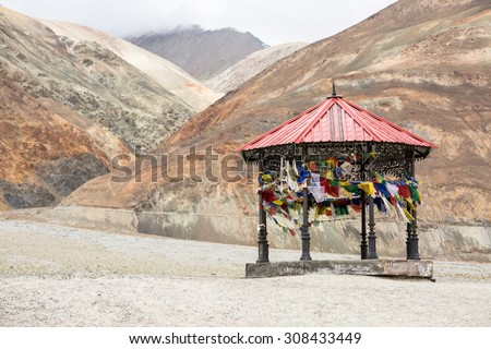 LEH LADAKH , INDIA - AUGUST 11 : The red roof wooden pavilion with praying flags is located beside Pangong lake in summer in Leh Ladakh,India on August 11, 2015.